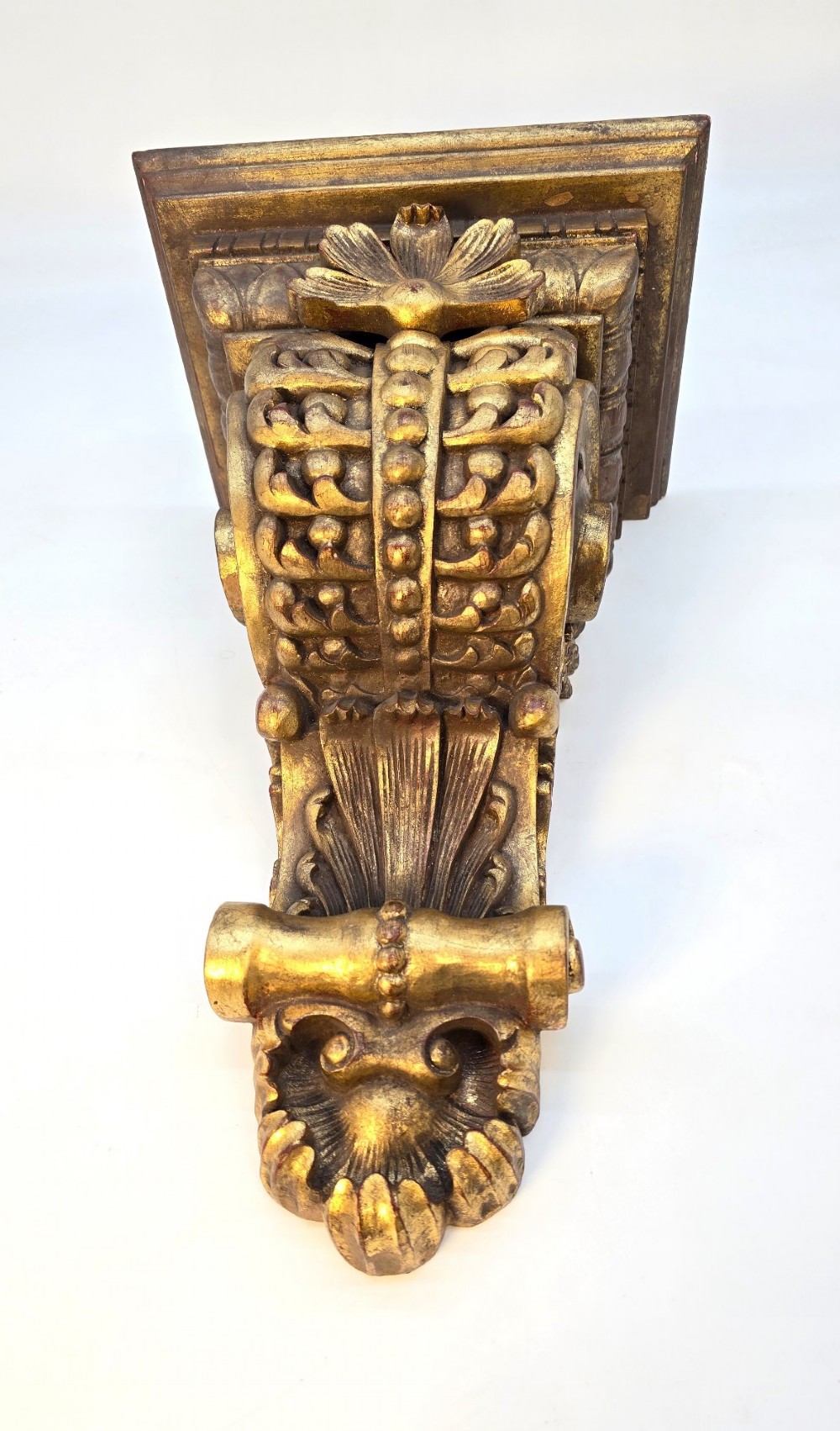 Pair of ornate Italian carved giltwood wall brackets featuring palmette leaf motifs and scrollwork finish. View II