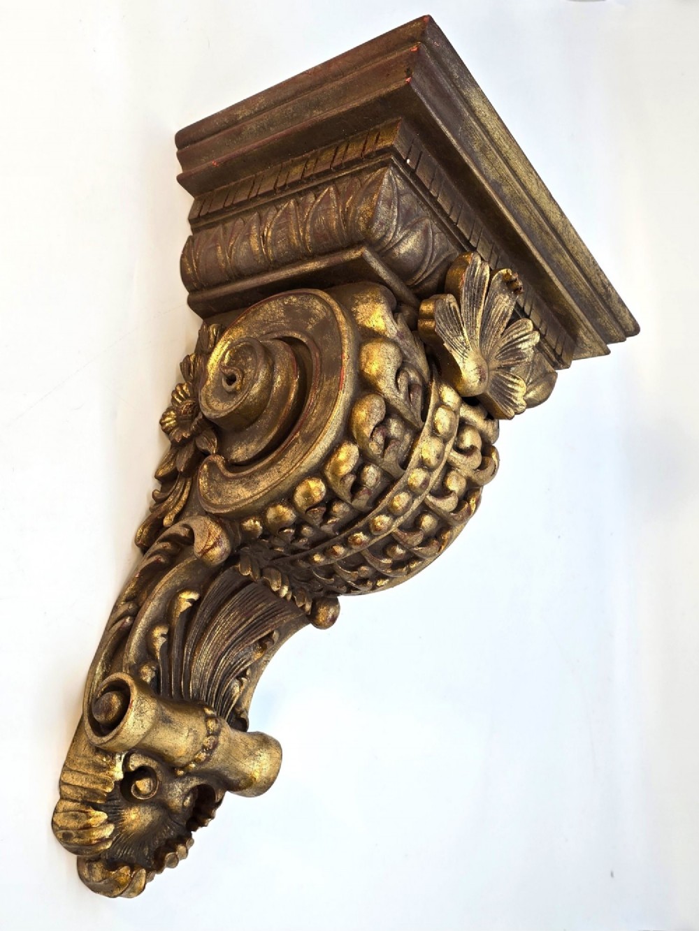 Pair of ornate Italian carved giltwood wall brackets featuring palmette leaf motifs and scrollwork finish. View III