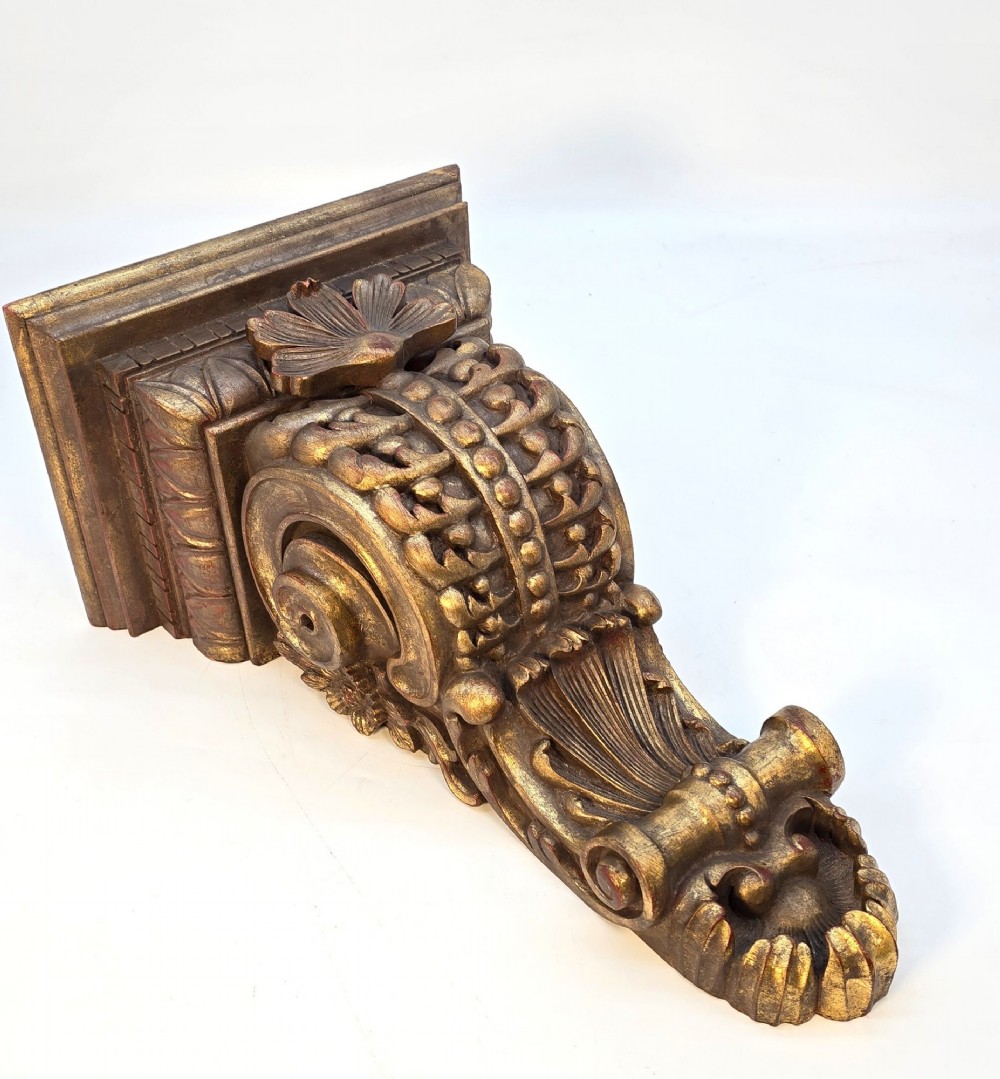 Pair of ornate Italian carved giltwood wall brackets featuring palmette leaf motifs and scrollwork finish. View VI