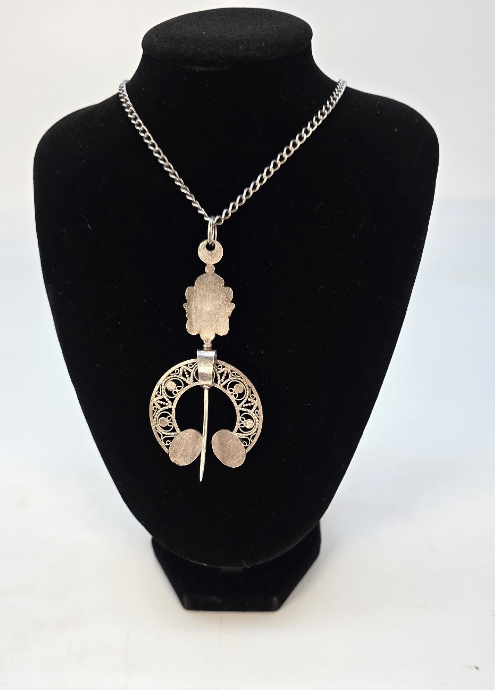 An antique late nineteenth-century French silver pendant in an Ottoman style featuring filigree work set with red and turquoise cabochons, suspended on a silver chain. View V