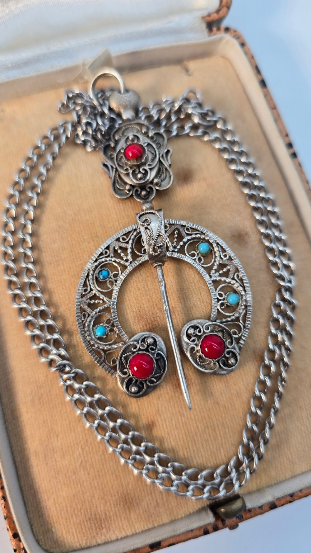An antique late nineteenth-century French silver pendant in an Ottoman style featuring filigree work set with red and turquoise cabochons, suspended on a silver chain. View XI