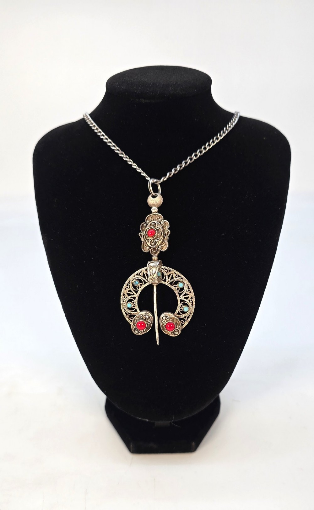 An antique late nineteenth-century French silver pendant in an Ottoman style featuring filigree work set with red and turquoise cabochons, suspended on a silver chain. View XIV