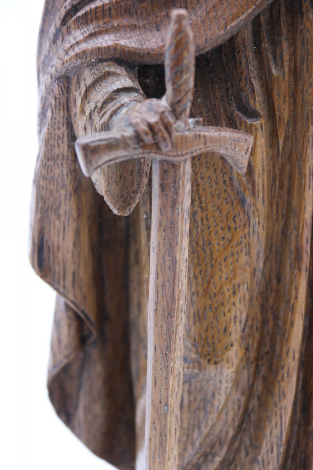 A carved oak wooden statue depicting Saint Paul holding a sword and scroll, standing on an octagonal wooden base. View XI