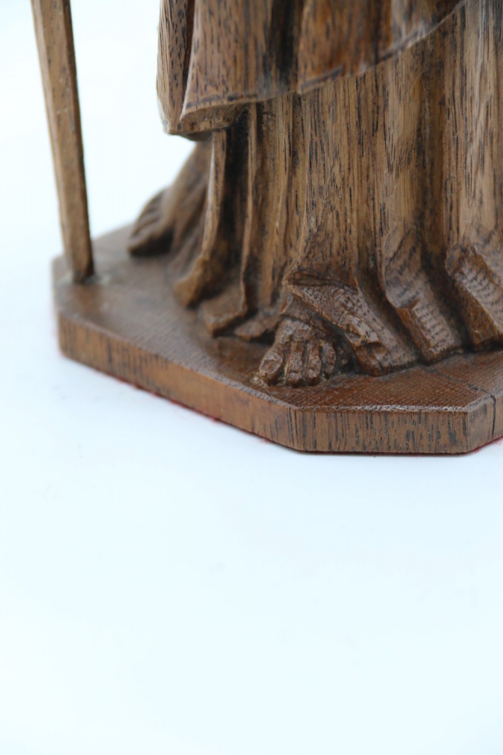 A carved oak wooden statue depicting Saint Paul holding a sword and scroll, standing on an octagonal wooden base. View XIII