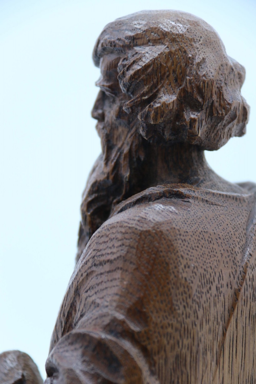 A carved oak wooden statue depicting Saint Paul holding a sword and scroll, standing on an octagonal wooden base. View XIV
