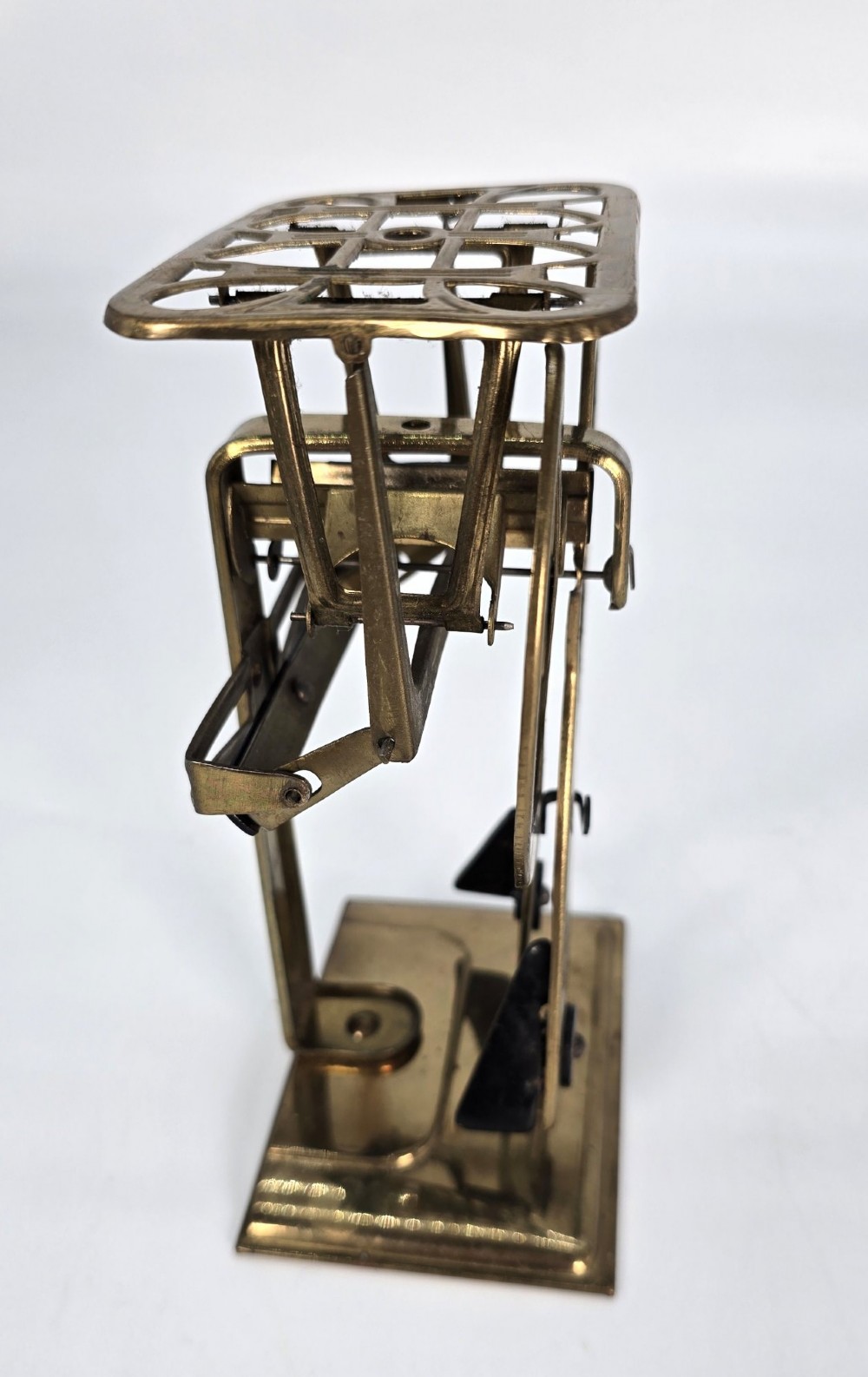 An Edwardian brass postal scale with an engraved curved measurement arc resting on a moulded rectangular base. View IV