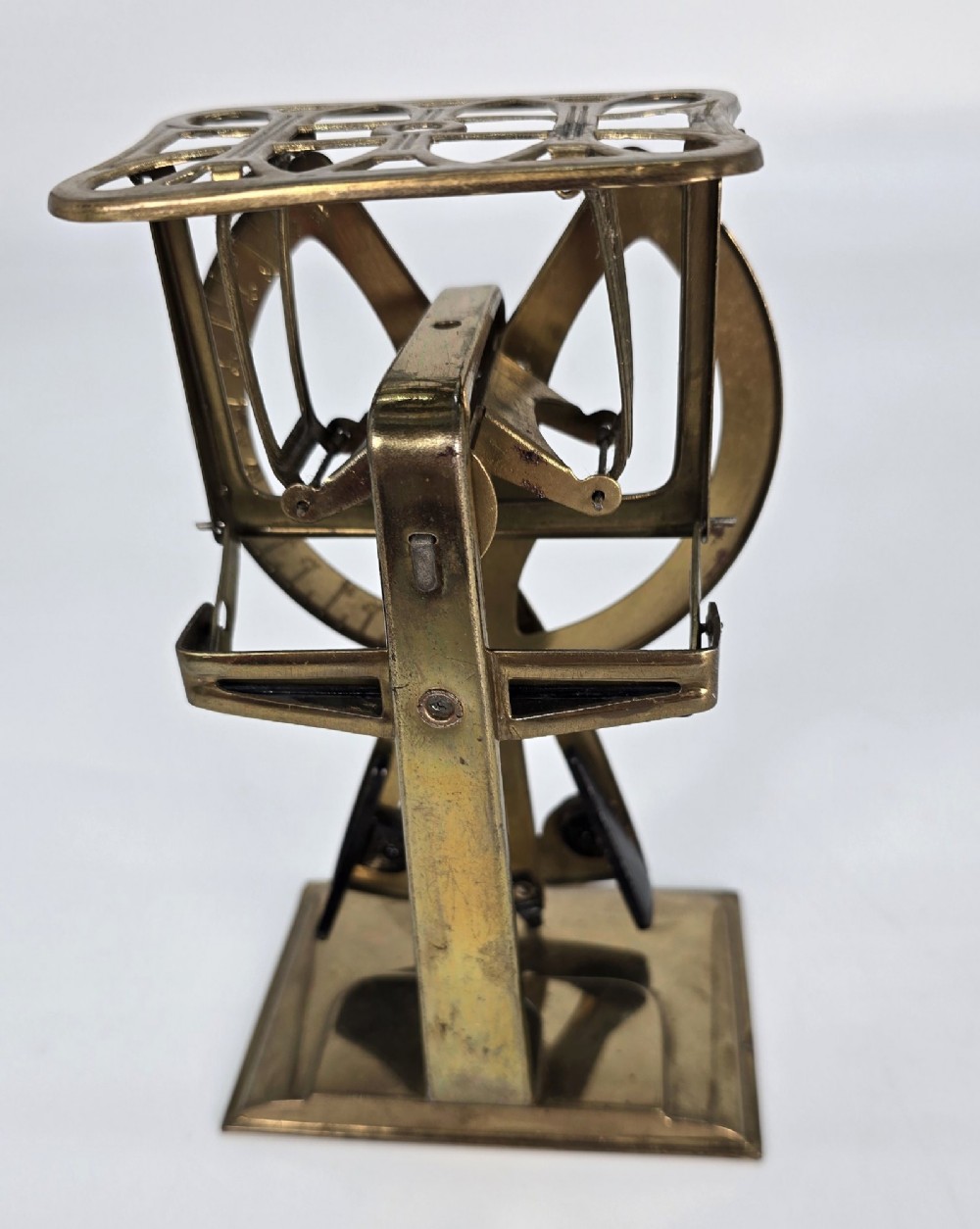 An Edwardian brass postal scale with an engraved curved measurement arc resting on a moulded rectangular base. View VI