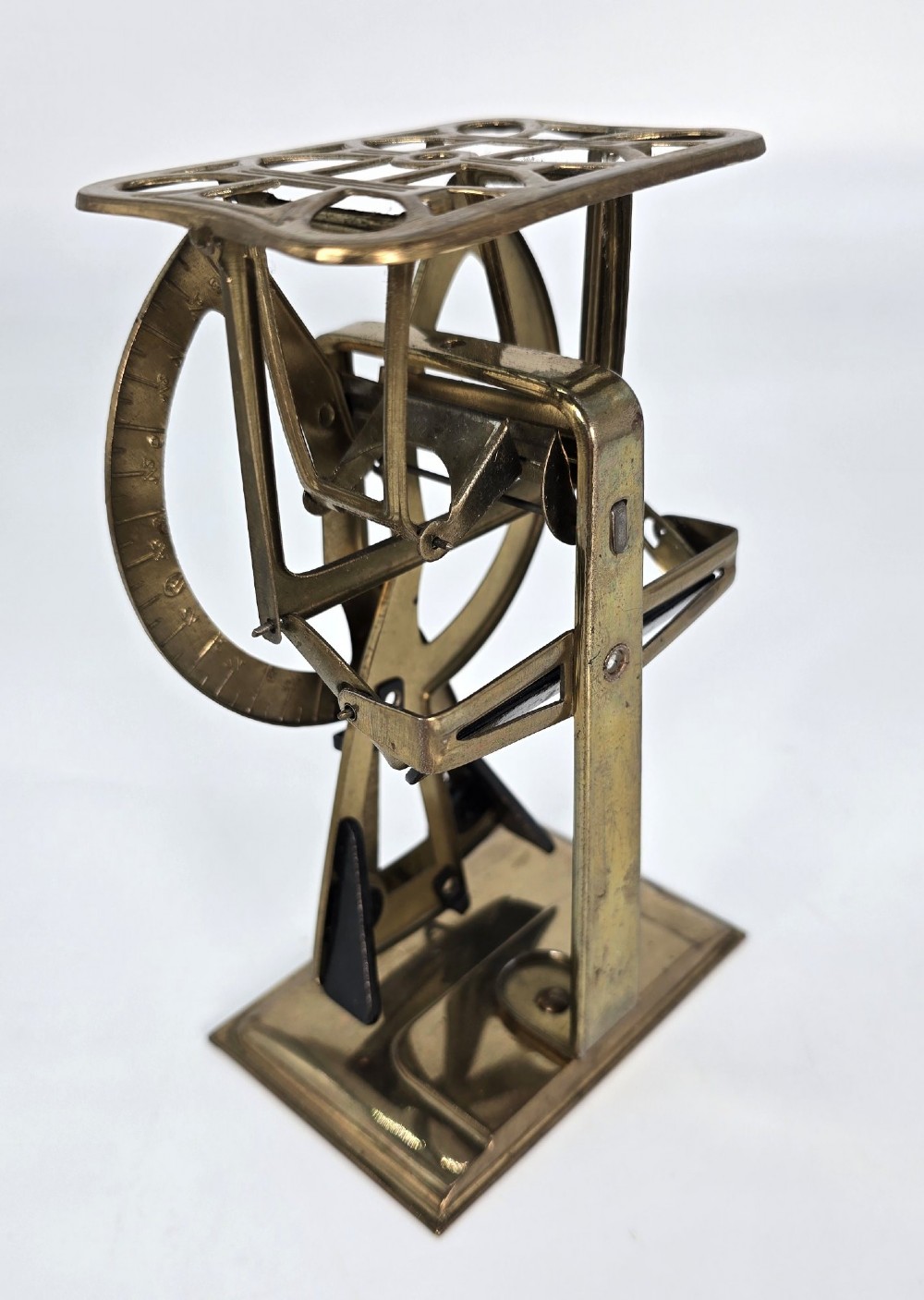 An Edwardian brass postal scale with an engraved curved measurement arc resting on a moulded rectangular base. View VII