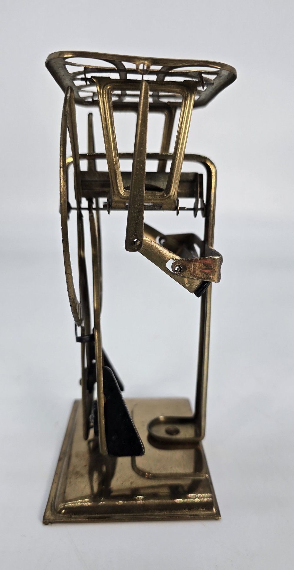 An Edwardian brass postal scale with an engraved curved measurement arc resting on a moulded rectangular base. View VIII
