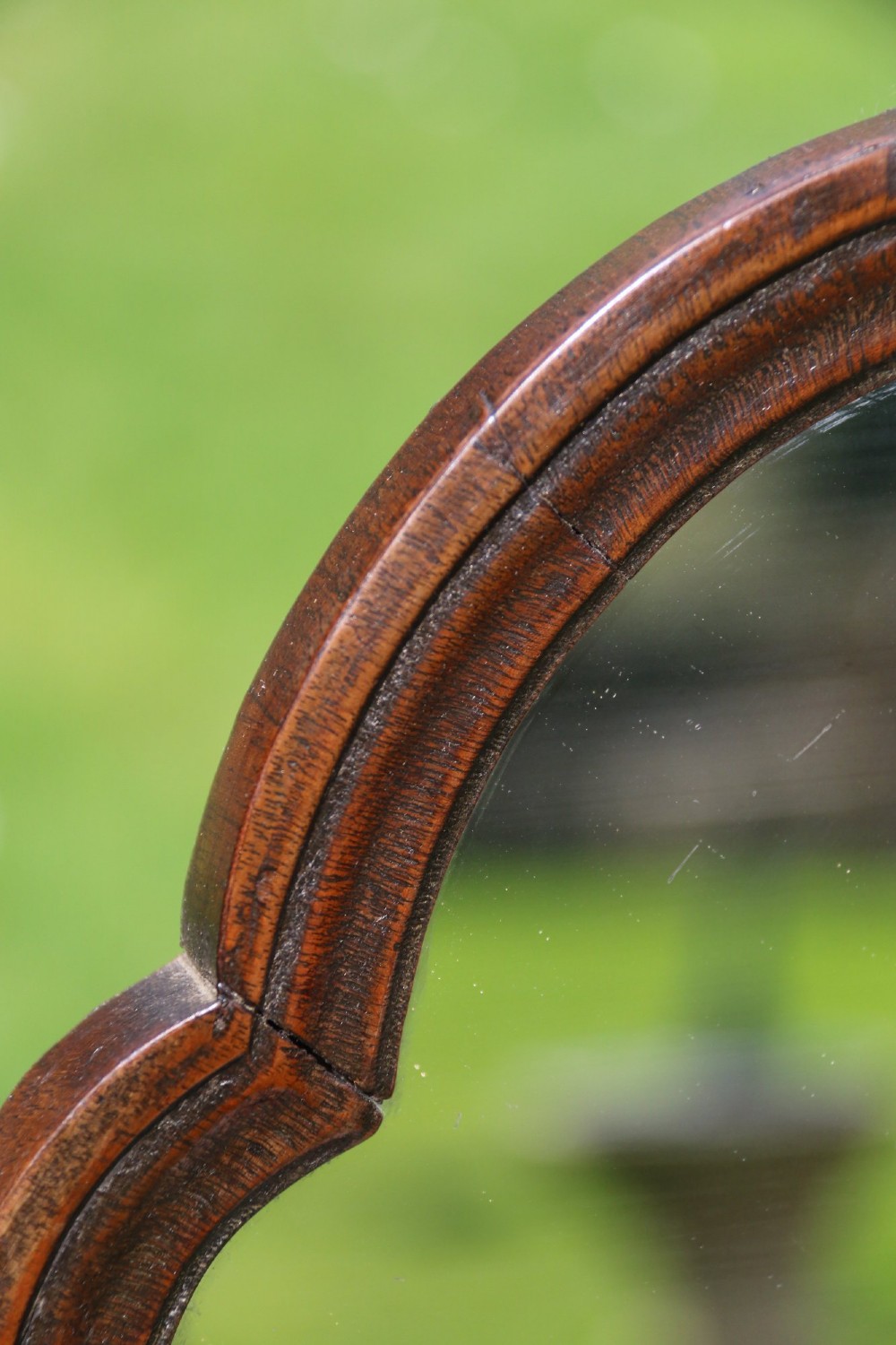 A Victorian figured walnut table mirror featuring an arched swivelling glass set above a slant-front miniature bureau base with a lower drawer. View IX