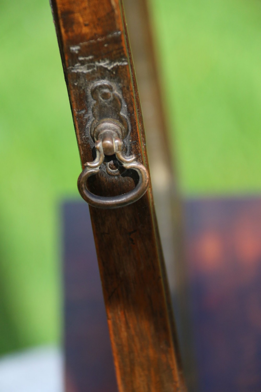 A Victorian figured walnut table mirror featuring an arched swivelling glass set above a slant-front miniature bureau base with a lower drawer. View XI