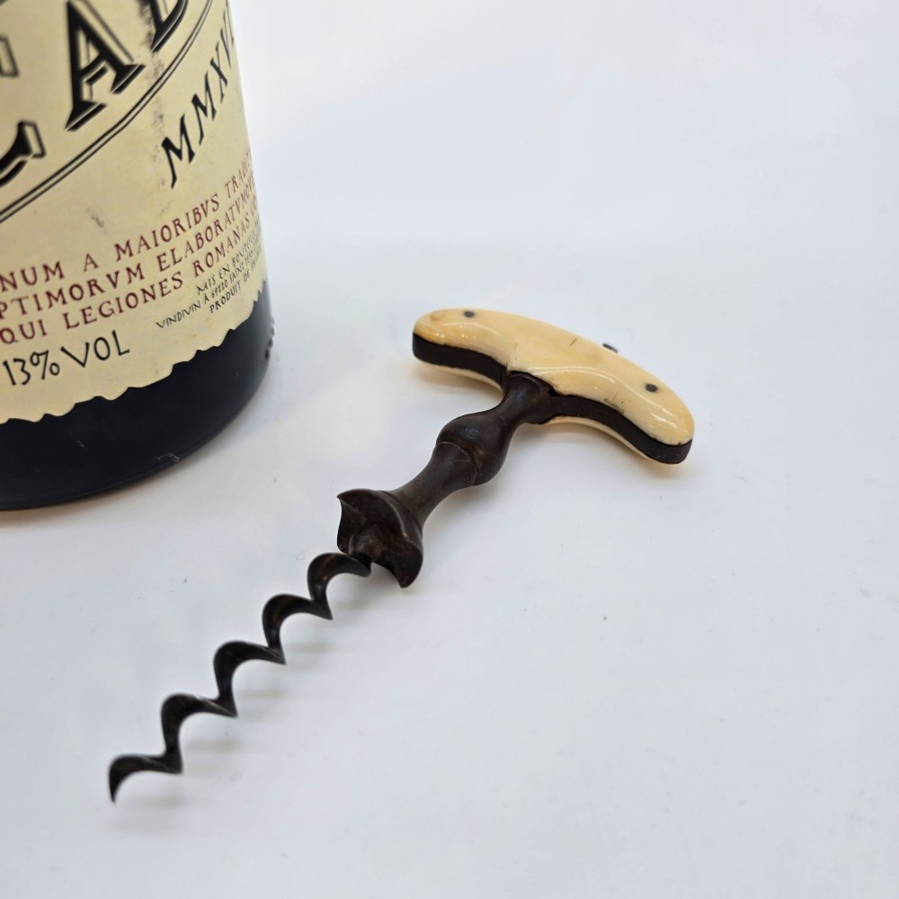 An early nineteenth-century corkscrew featuring a curved cream-coloured bone handle and a turned dark wood shaft with a steel helix. View II