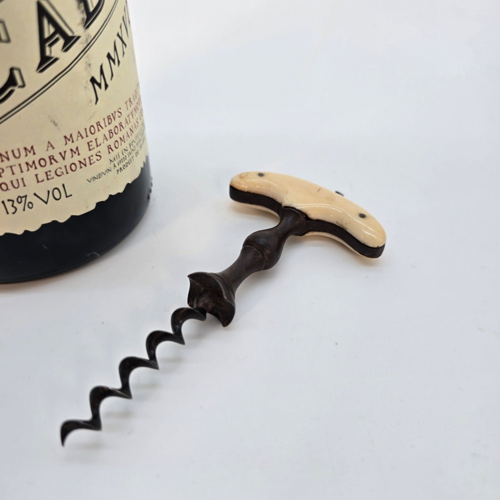 An early nineteenth-century corkscrew featuring a curved cream-coloured bone handle and a turned dark wood shaft with a steel helix. View III