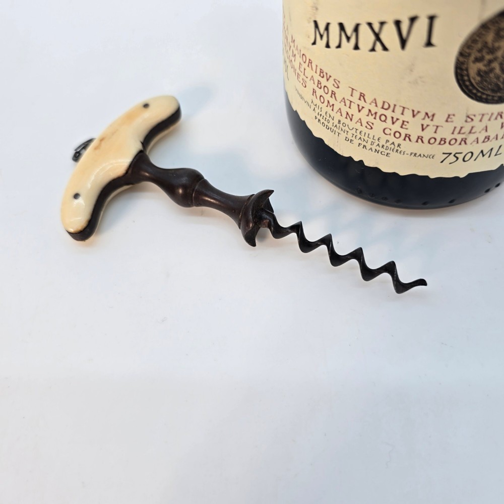 An early nineteenth-century corkscrew featuring a curved cream-coloured bone handle and a turned dark wood shaft with a steel helix. View IV