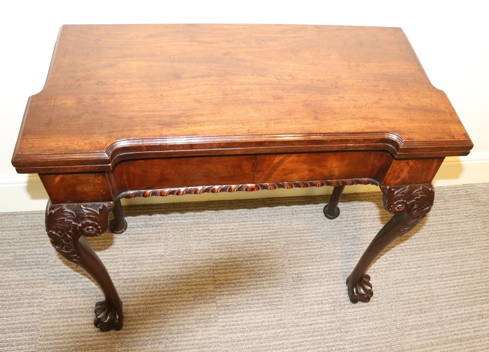 An 18th-century mahogany fold-out card table with a green baize inset top, corner candle stands, and carved cabriole legs ending in claw and ball feet. View II