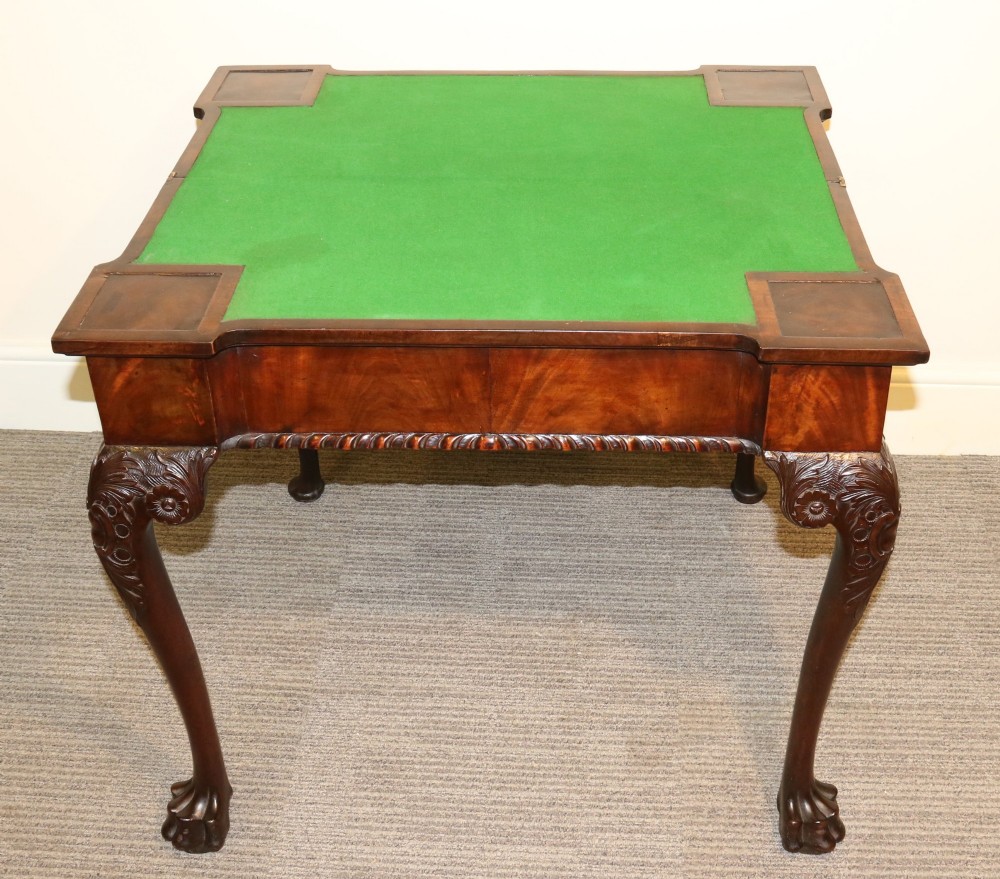 An 18th-century mahogany fold-out card table with a green baize inset top, corner candle stands, and carved cabriole legs ending in claw and ball feet. View III