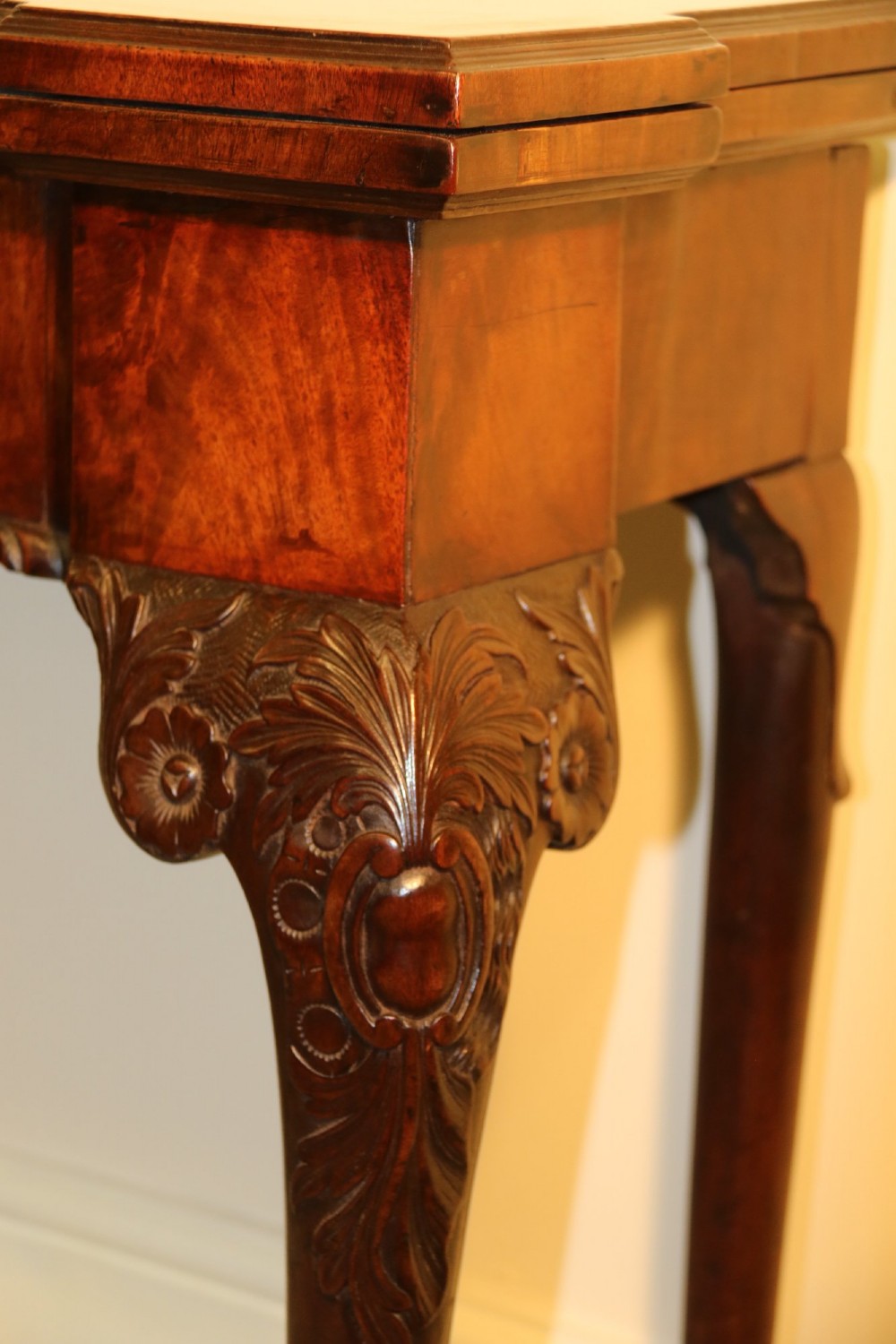 An 18th-century mahogany fold-out card table with a green baize inset top, corner candle stands, and carved cabriole legs ending in claw and ball feet. View VIII