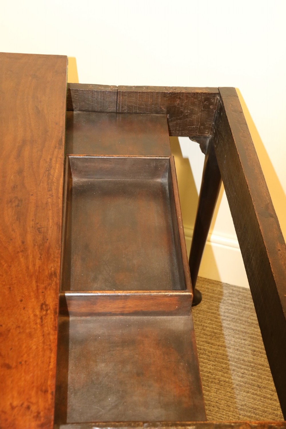 An 18th-century mahogany fold-out card table with a green baize inset top, corner candle stands, and carved cabriole legs ending in claw and ball feet. View XII
