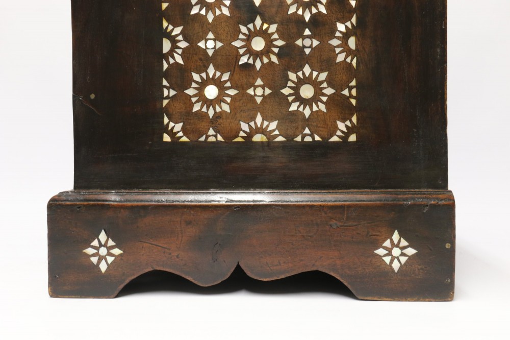 A dark hardwood tabletop chest featuring three drawers decorated with geometric bone inlay and turned wooden knobs. View VII