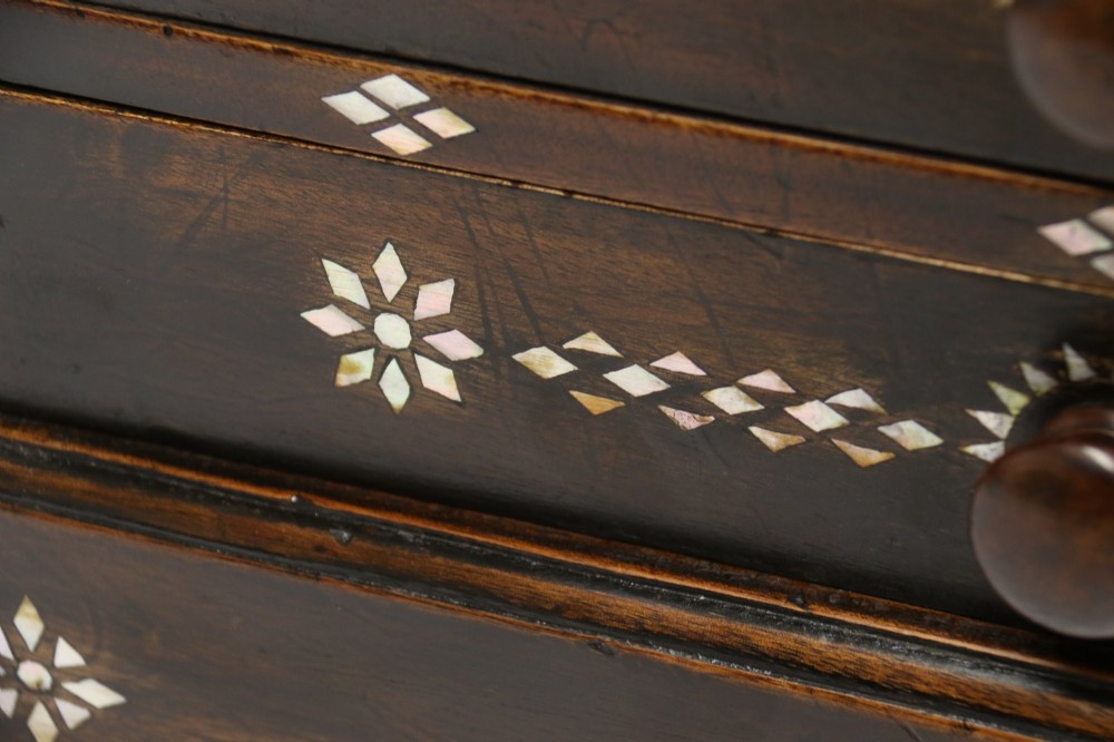 A dark hardwood tabletop chest featuring three drawers decorated with geometric bone inlay and turned wooden knobs. View VIII