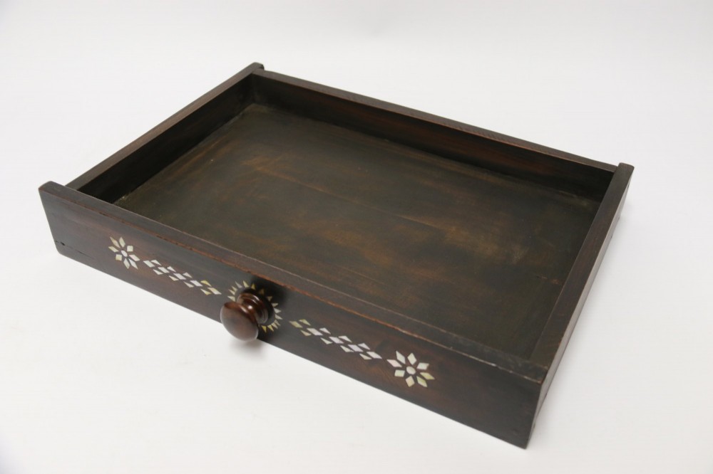 A dark hardwood tabletop chest featuring three drawers decorated with geometric bone inlay and turned wooden knobs. View X