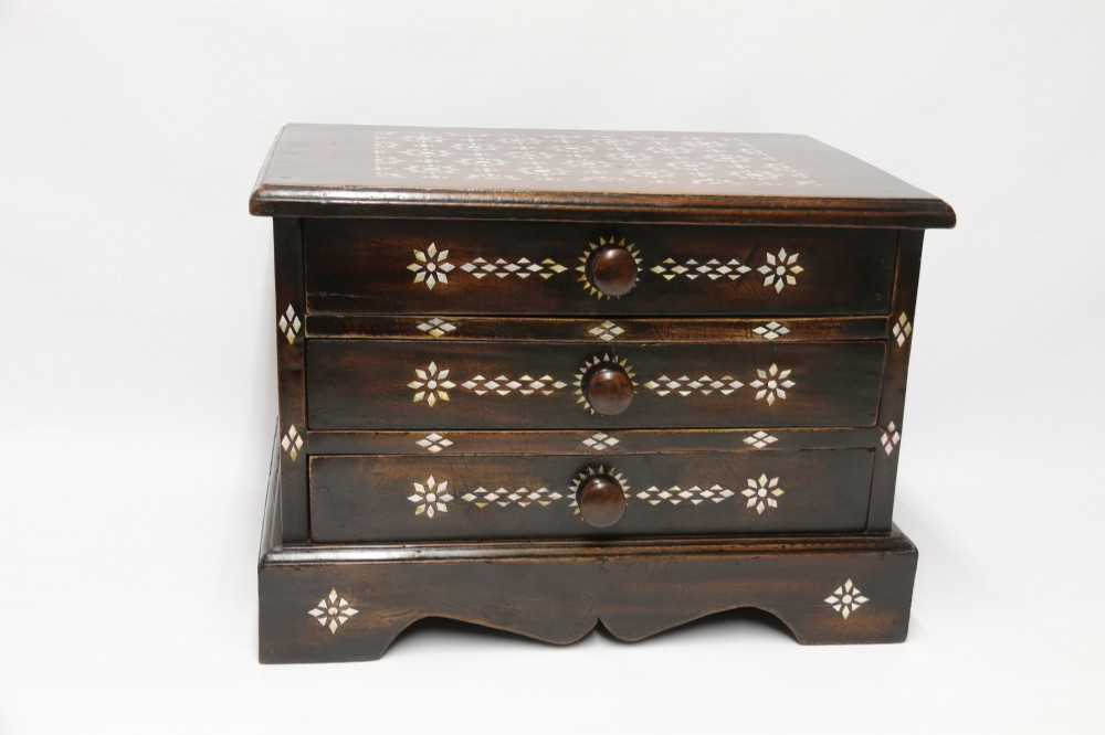 A dark hardwood tabletop chest featuring three drawers decorated with geometric bone inlay and turned wooden knobs. View XII