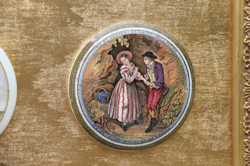 A large rectangular ornate gilt frame displaying thirty-five circular Victorian polychrome transfer-printed ceramic pot lids mounted in grid formation. View VII