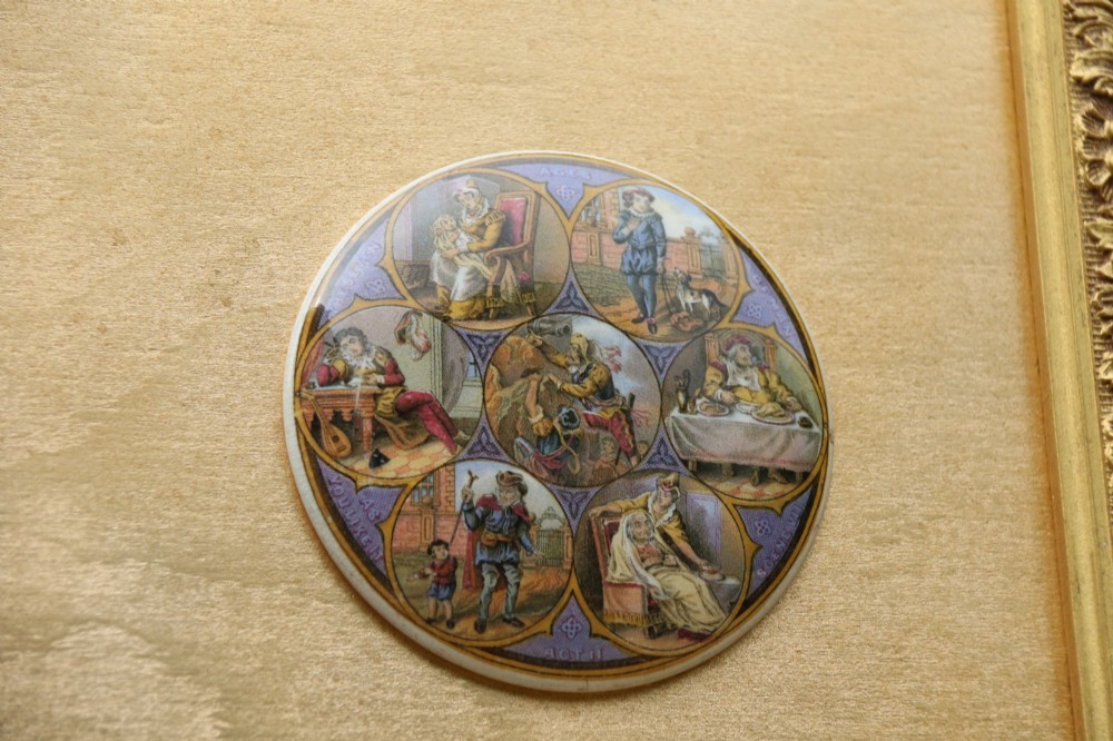 A large rectangular ornate gilt frame displaying thirty-five circular Victorian polychrome transfer-printed ceramic pot lids mounted in grid formation. View IX