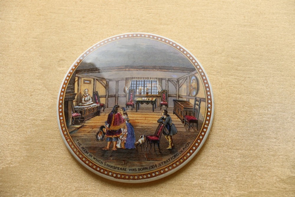 A large rectangular ornate gilt frame displaying thirty-five circular Victorian polychrome transfer-printed ceramic pot lids mounted in grid formation. View X
