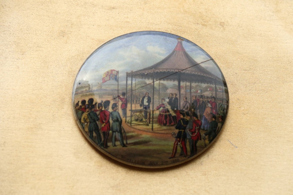 A large rectangular ornate gilt frame displaying thirty-five circular Victorian polychrome transfer-printed ceramic pot lids mounted in grid formation. View XI