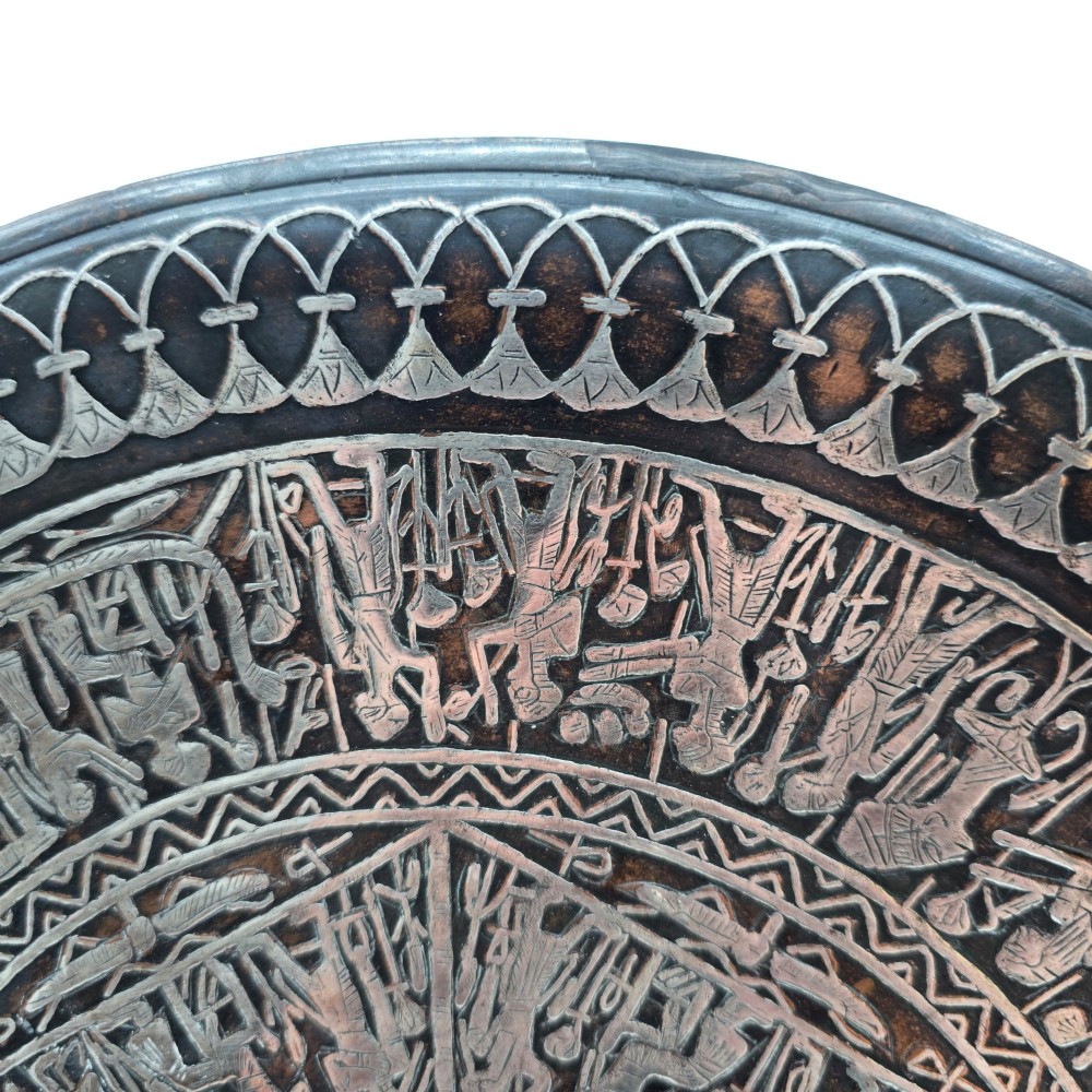 A circular antique Egyptian Cairo Ware wall charger made of dark copper intricately inlaid with silver depicting Pharaonic figures, pyramids, and hieroglyphs. View VII