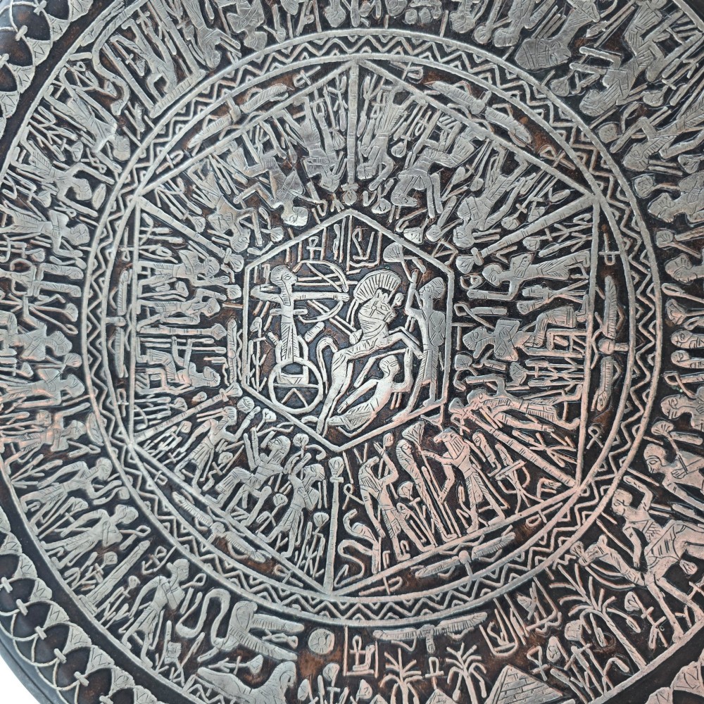A circular antique Egyptian Cairo Ware wall charger made of dark copper intricately inlaid with silver depicting Pharaonic figures, pyramids, and hieroglyphs. View VIII
