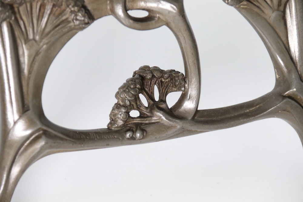 An Art Nouveau pewter table mirror featuring an asymmetrical botanical frame with organic crests and an easel back support. View III