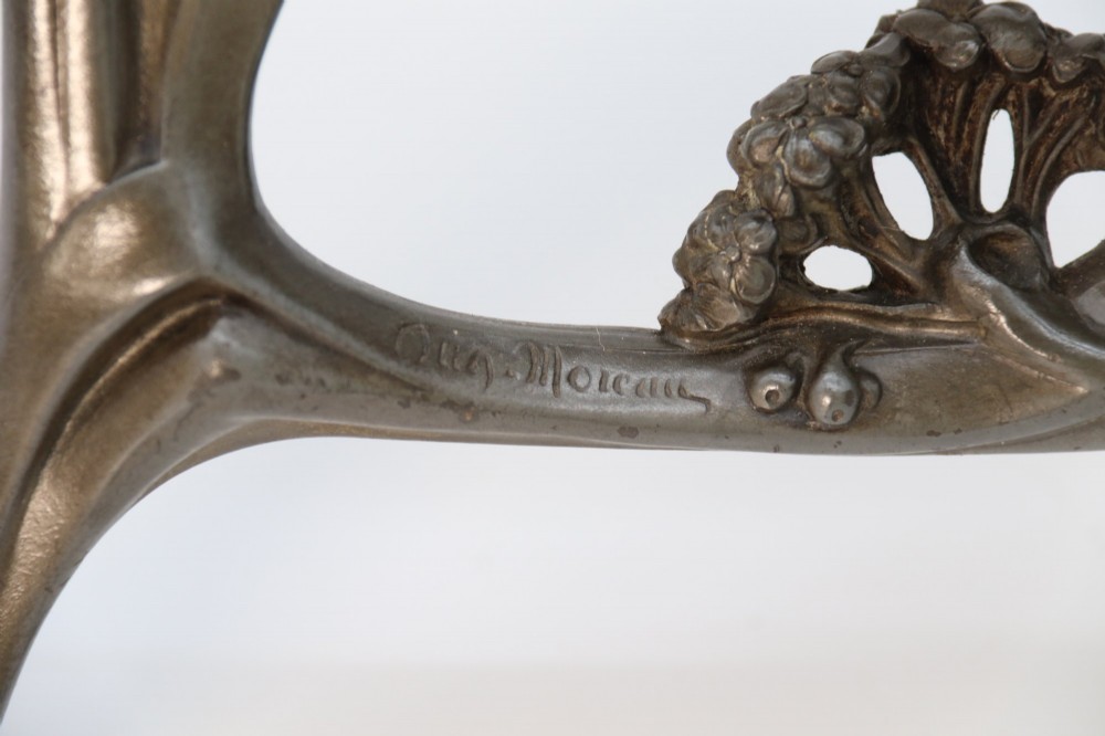 An Art Nouveau pewter table mirror featuring an asymmetrical botanical frame with organic crests and an easel back support. View VI