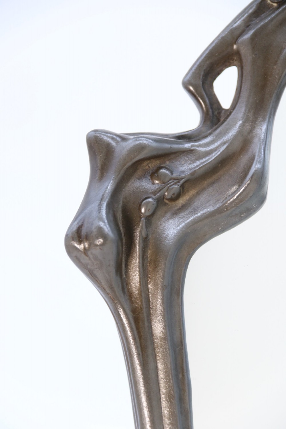 An Art Nouveau pewter table mirror featuring an asymmetrical botanical frame with organic crests and an easel back support. View XIII