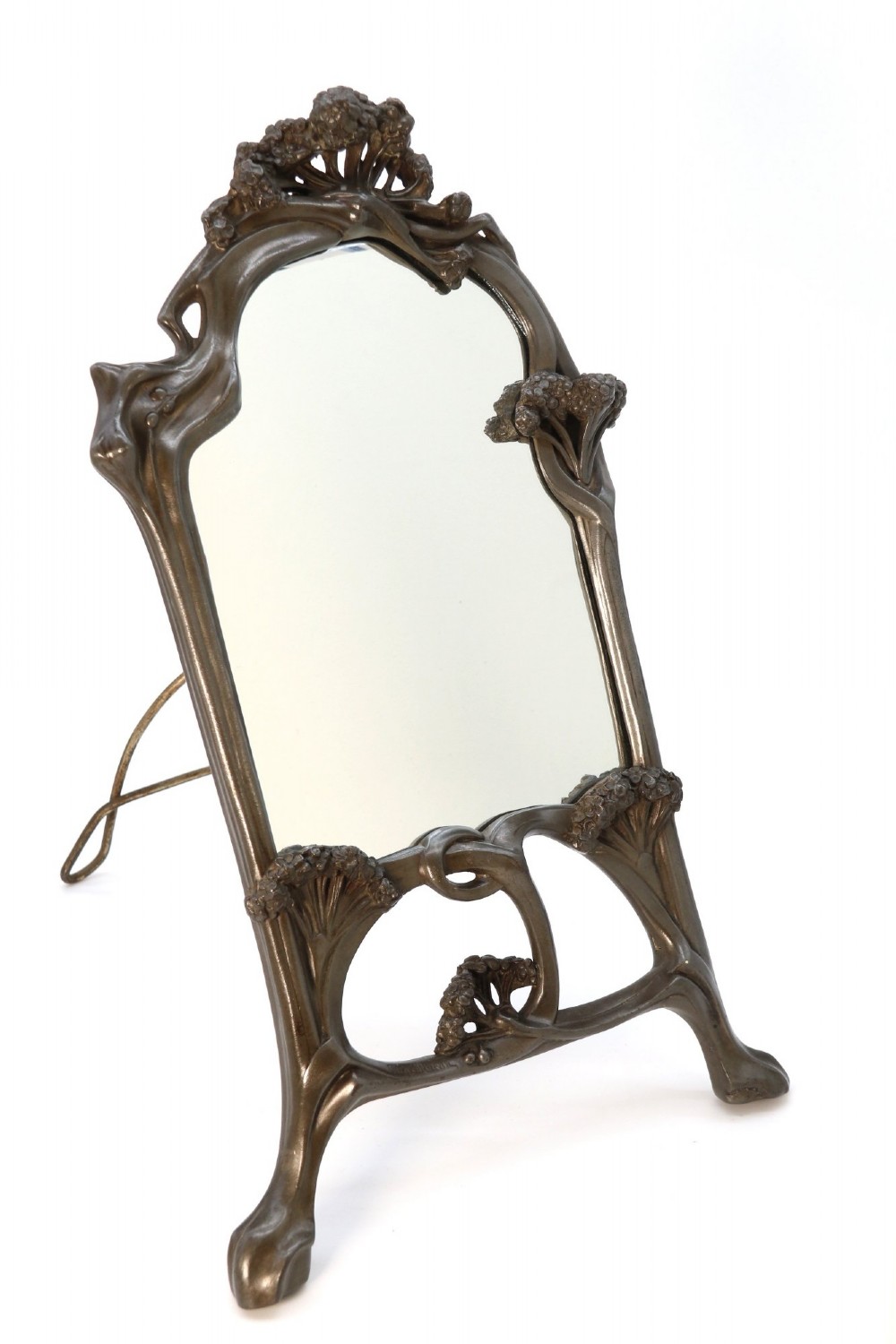 An Art Nouveau pewter table mirror featuring an asymmetrical botanical frame with organic crests and an easel back support. View XIV