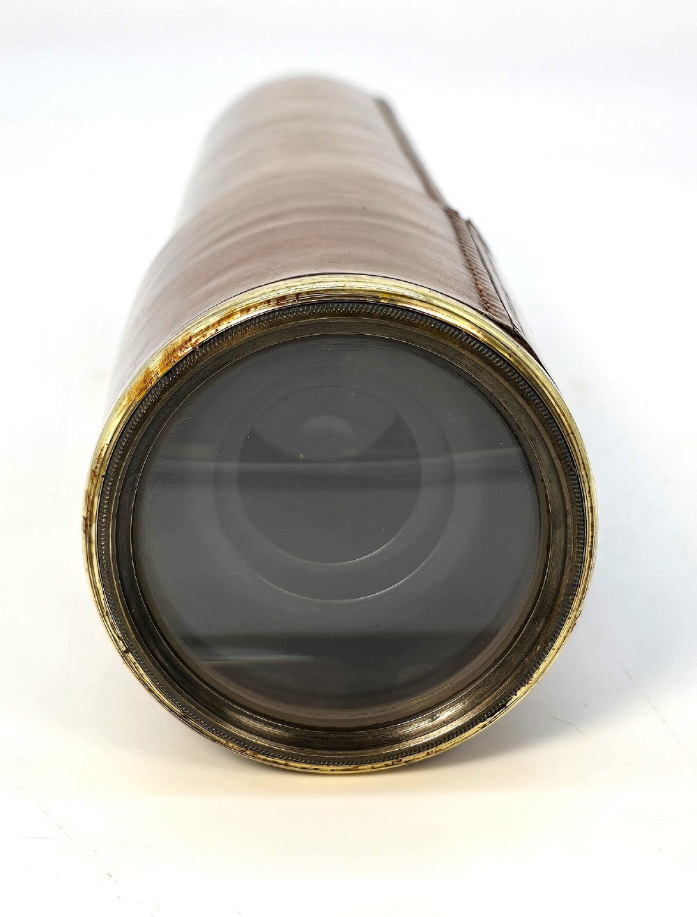 A brass multi-draw military telescope featuring stitched brown leather protective sleeves along the barrel. View III