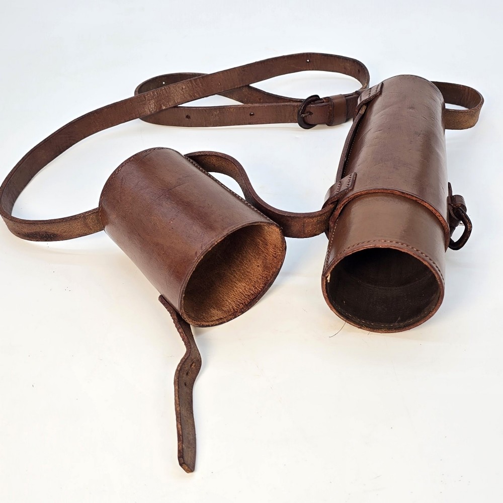 A brass multi-draw military telescope featuring stitched brown leather protective sleeves along the barrel. View VI