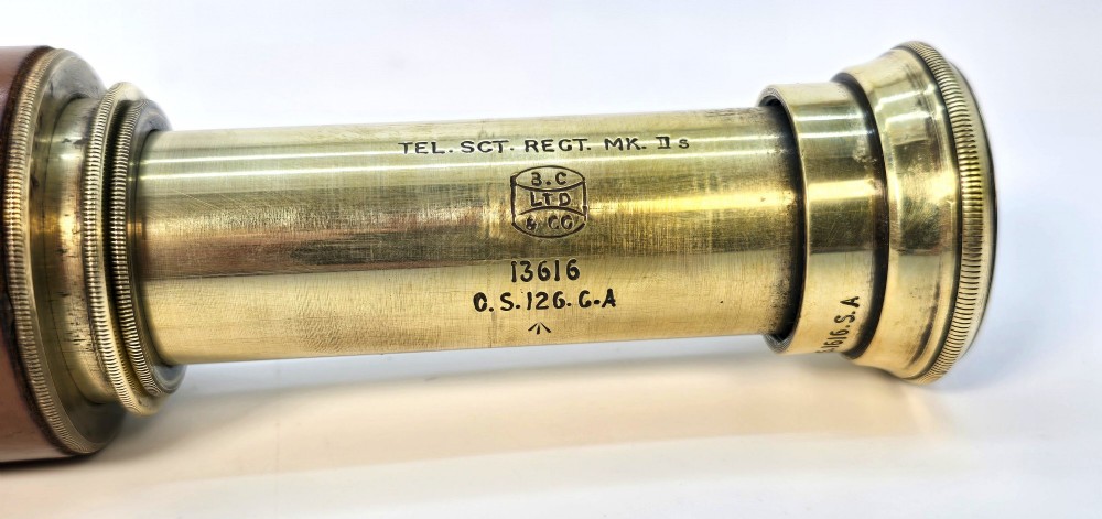 A brass multi-draw military telescope featuring stitched brown leather protective sleeves along the barrel. View VIII