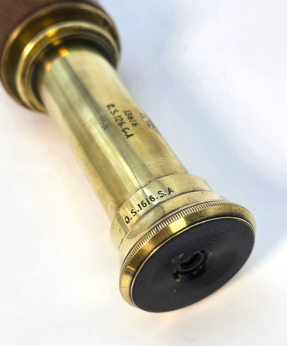 A brass multi-draw military telescope featuring stitched brown leather protective sleeves along the barrel. View IX