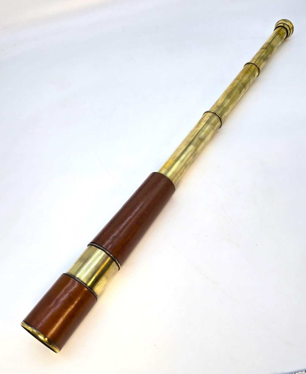 A brass multi-draw military telescope featuring stitched brown leather protective sleeves along the barrel. View XIII