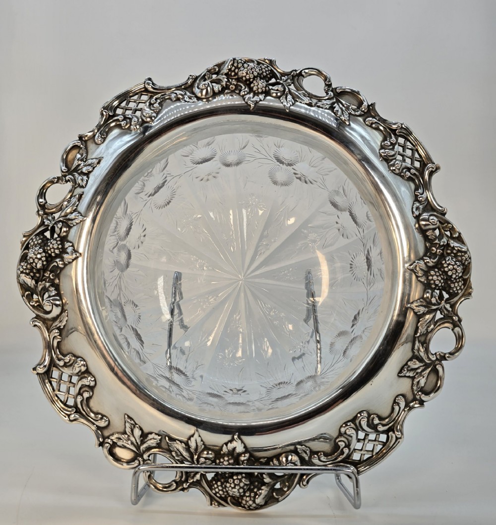 A clear crystal bowl featuring an intricately chased sterling silver rim decorated with floral motifs, scrolls, and lattice patterns. View XIII