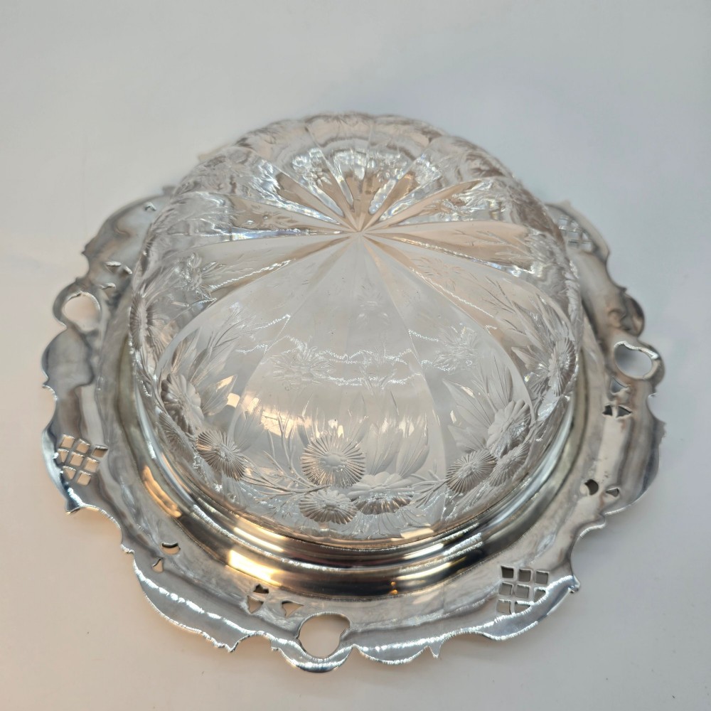 A clear crystal bowl featuring an intricately chased sterling silver rim decorated with floral motifs, scrolls, and lattice patterns. View XIV