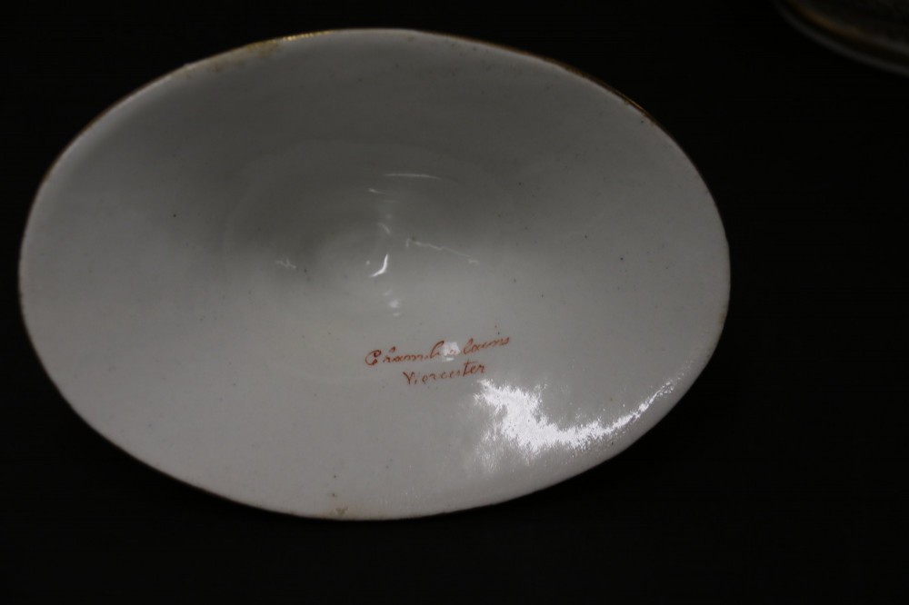 An antique white porcelain covered sucrier decorated with intricate gold scroll patterning, geometric trim, twin loop handles, and a pointed finial lid. View VII