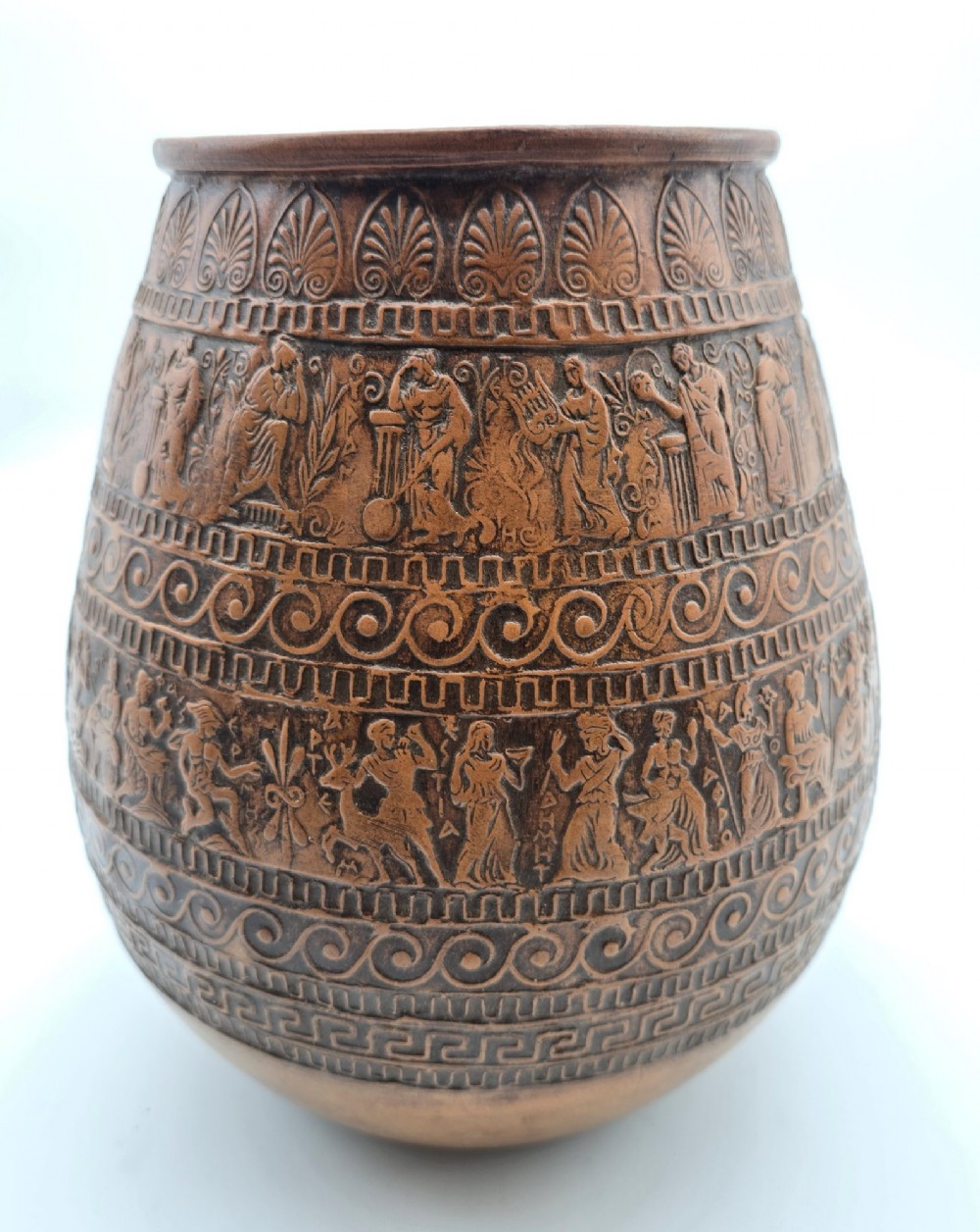 A round terracotta vase decorated with bands of relief-carved Greek classical figures, scrollwork, and geometric meander patterns. View III