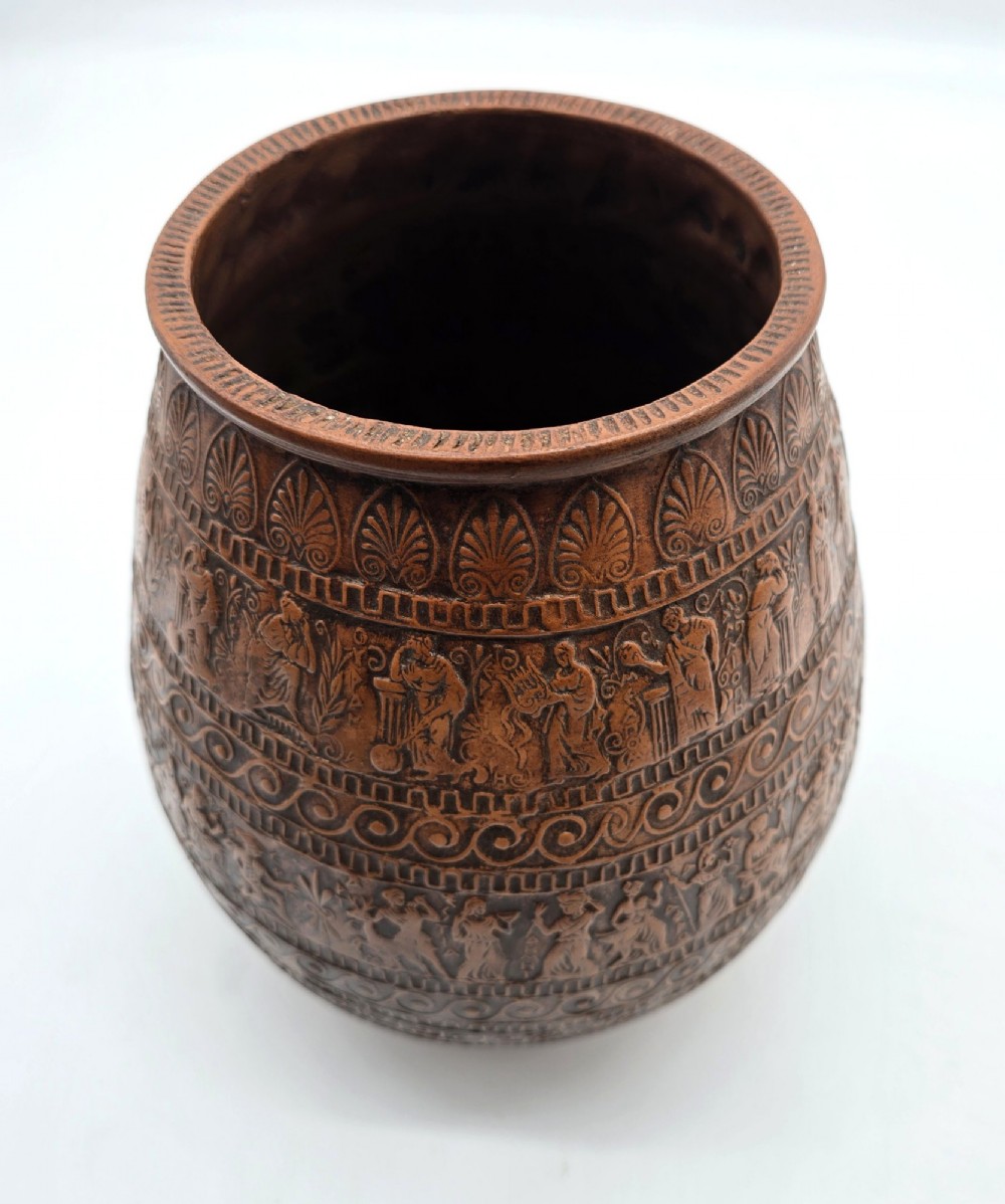 A round terracotta vase decorated with bands of relief-carved Greek classical figures, scrollwork, and geometric meander patterns. View IV