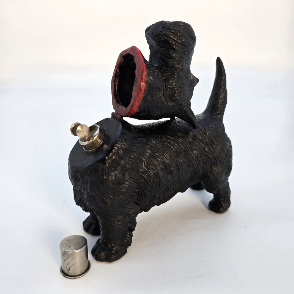 A hand-painted black cast metal table lighter shaped as a standing Scottish Terrier dog with a red collar. View II