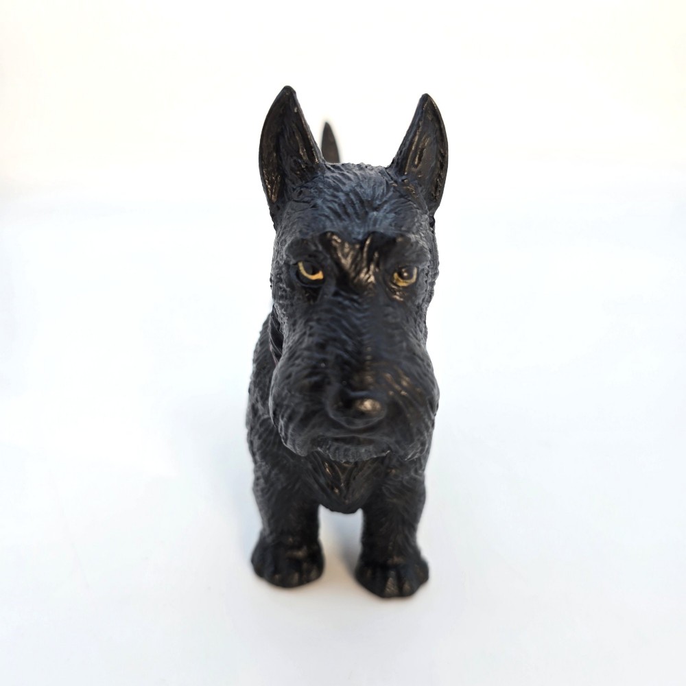 A hand-painted black cast metal table lighter shaped as a standing Scottish Terrier dog with a red collar. View III
