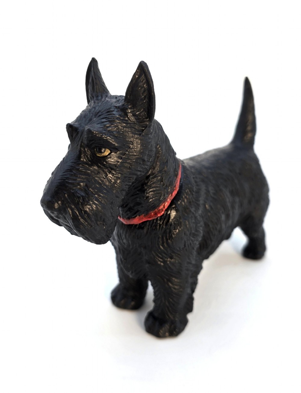 A hand-painted black cast metal table lighter shaped as a standing Scottish Terrier dog with a red collar. View IV