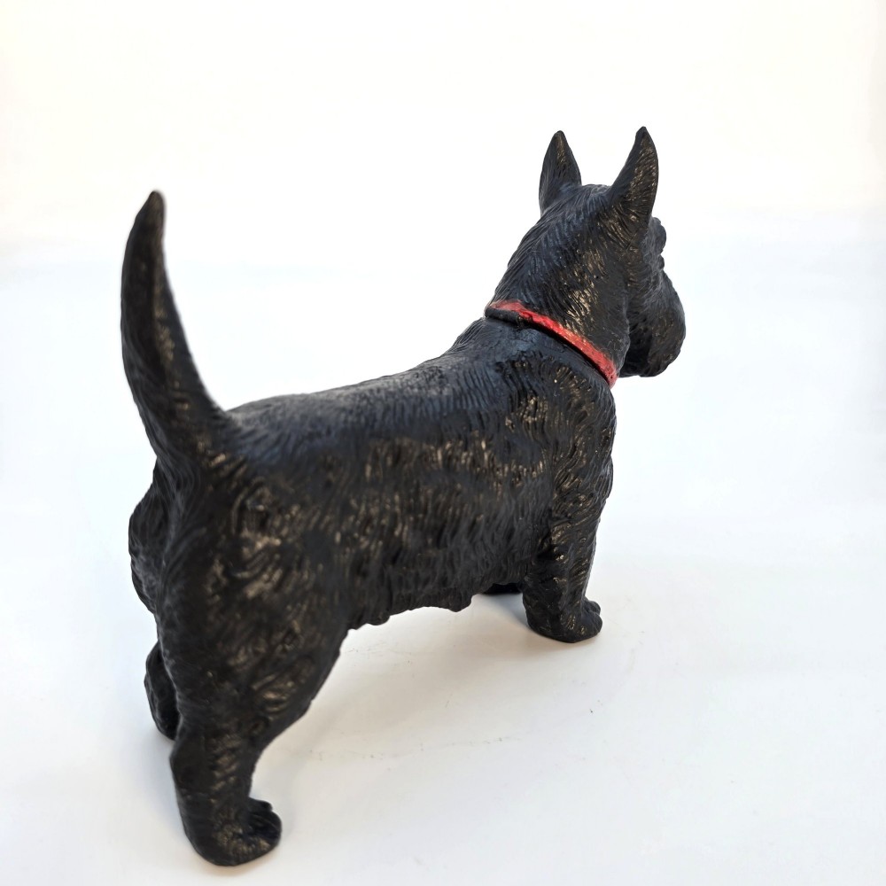 A hand-painted black cast metal table lighter shaped as a standing Scottish Terrier dog with a red collar. View VII